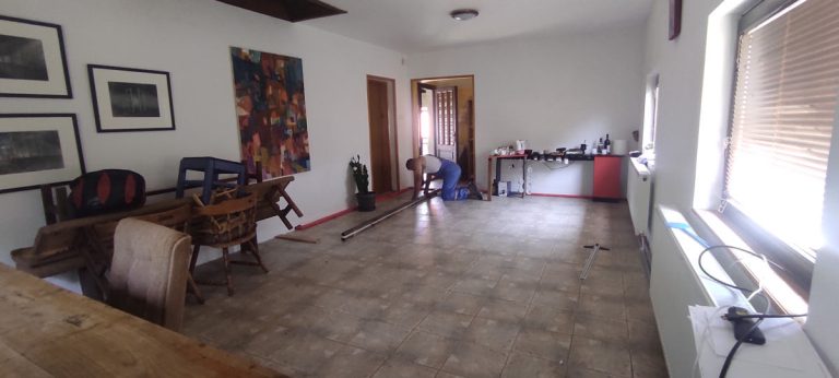 a worker installing a floor planks in a room