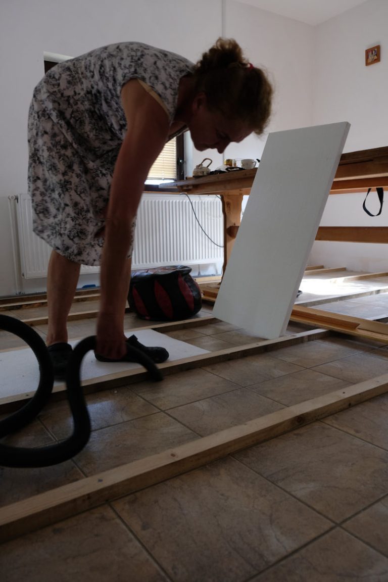 a woman vacuuming a floor