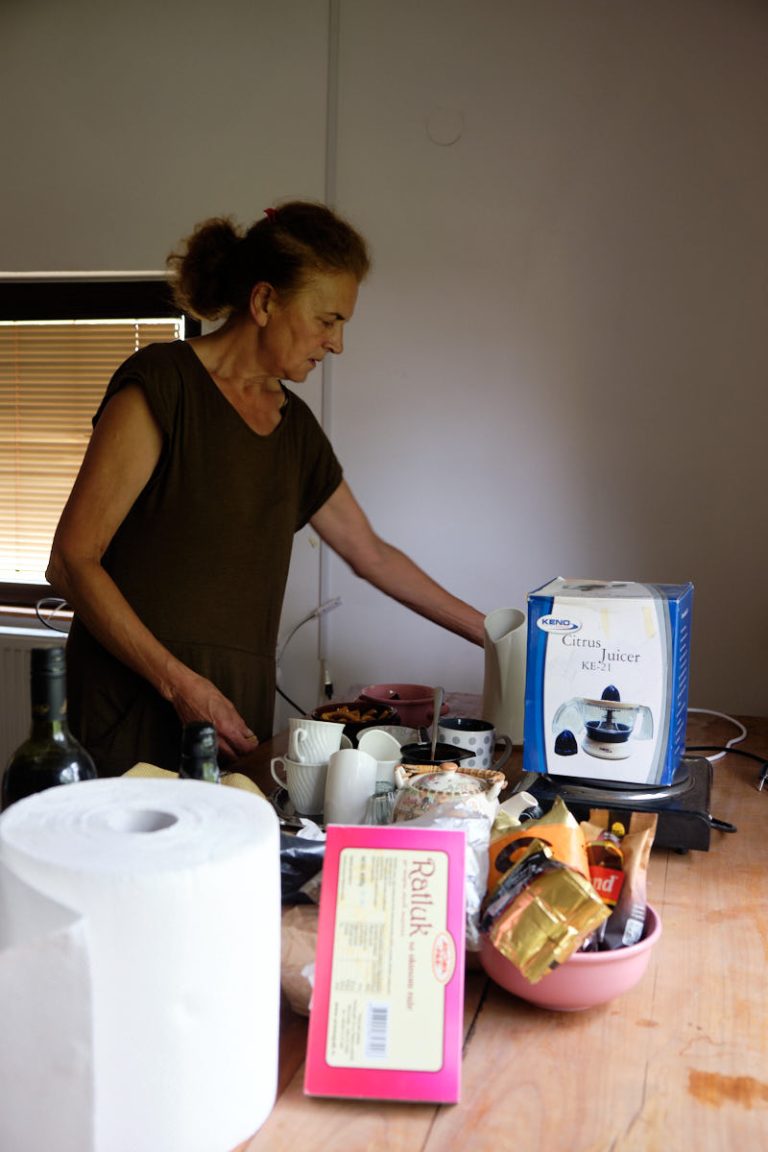 a woman and kitchen stuff on a table