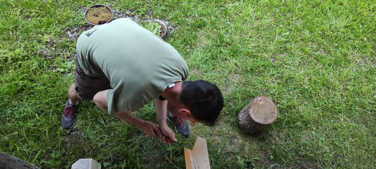 a man making a joint with a chisle