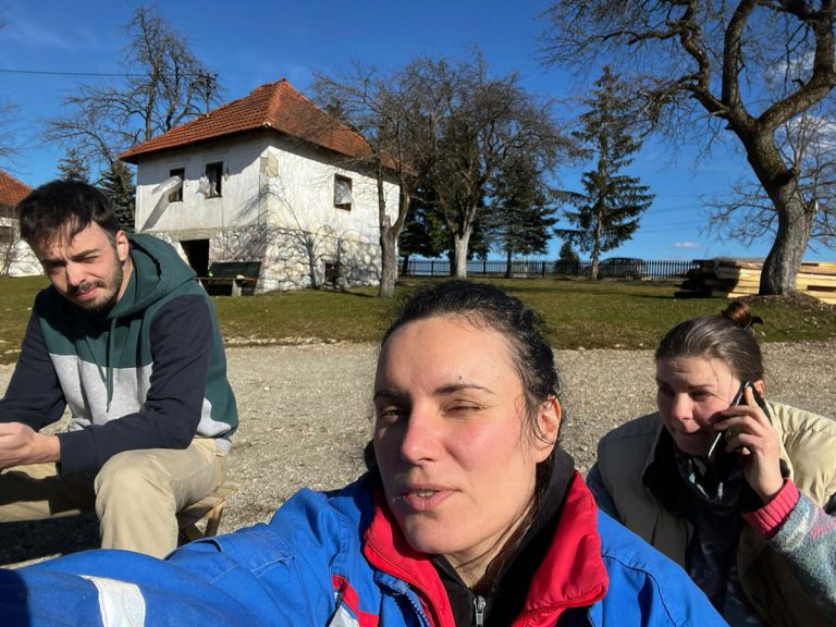 two girls and a boy taking a break from work on a sunny day