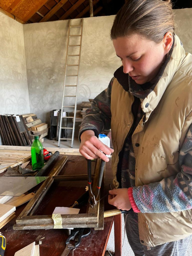 a girl disassembling an old window