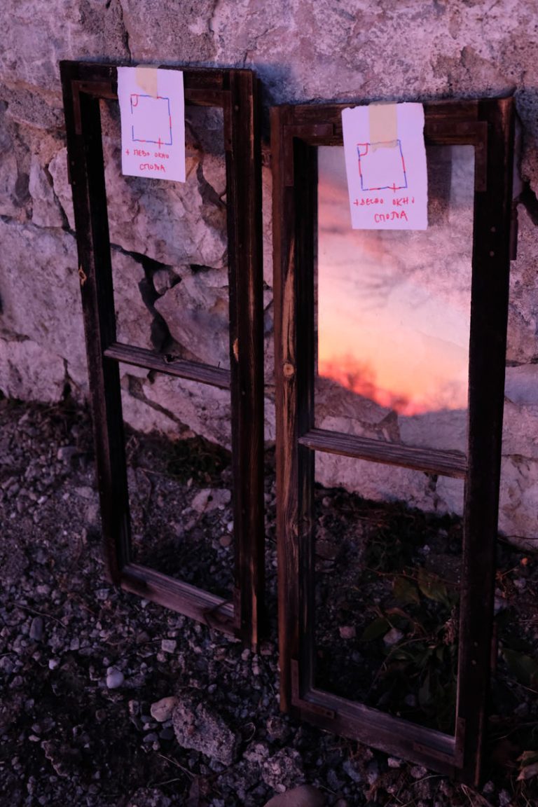 old windows with the reflection of a sunset