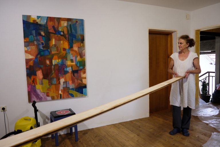 a woman holding a wooden plank