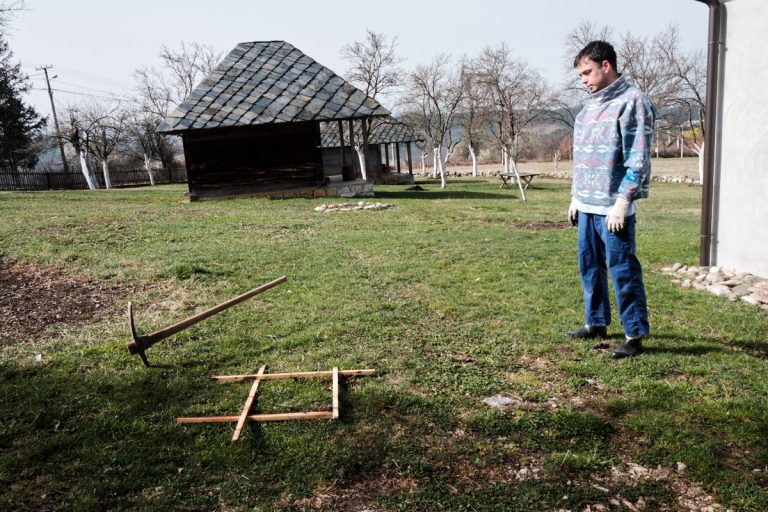 a man looking at spot for a hole to plant a tree