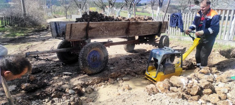 people digging a water channel