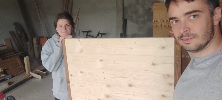 a man and a woman with a wooden platform