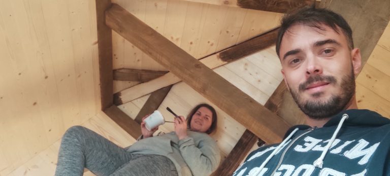 a boy and a girl painting the rafters