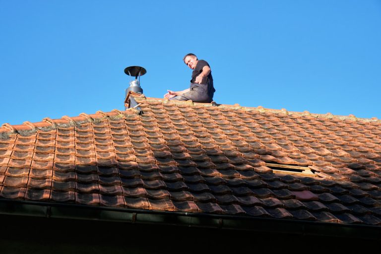 a worker on a roof installing a chimney
