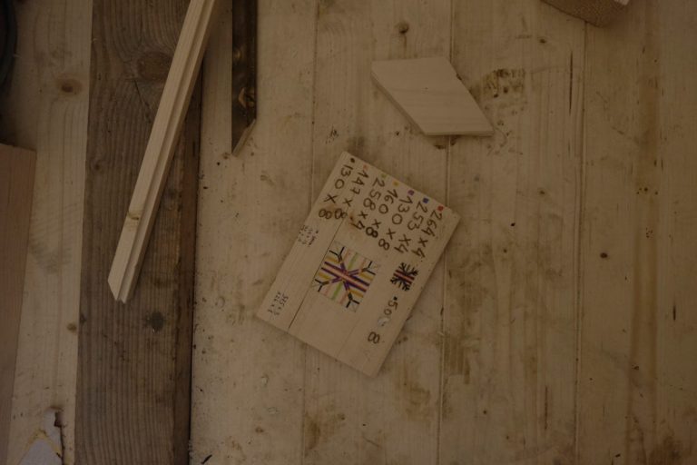 a wooden plate with a technical drawing