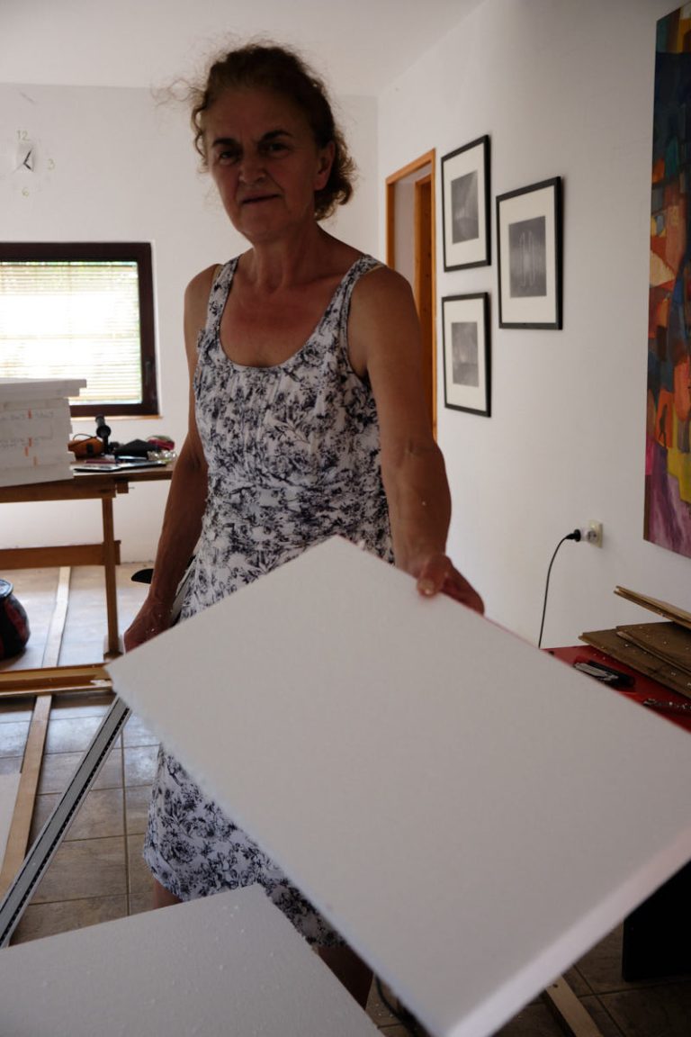 a woman holding a styrofoam board