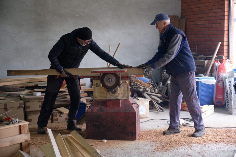 workers plaining a wooden board