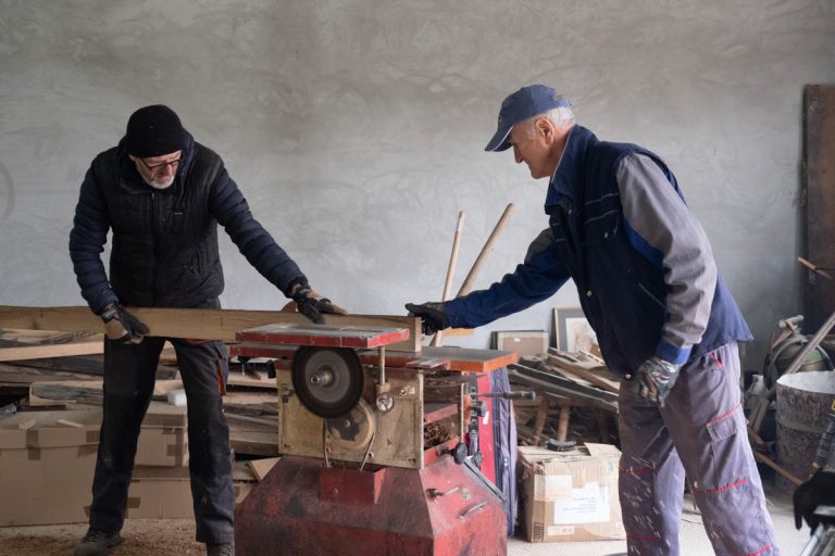 workers plaining a wooden board