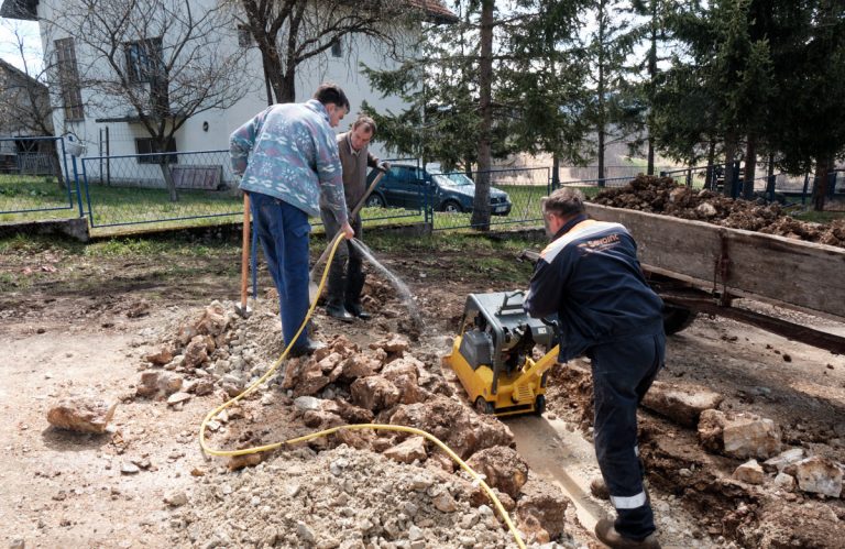 people digging a water channel