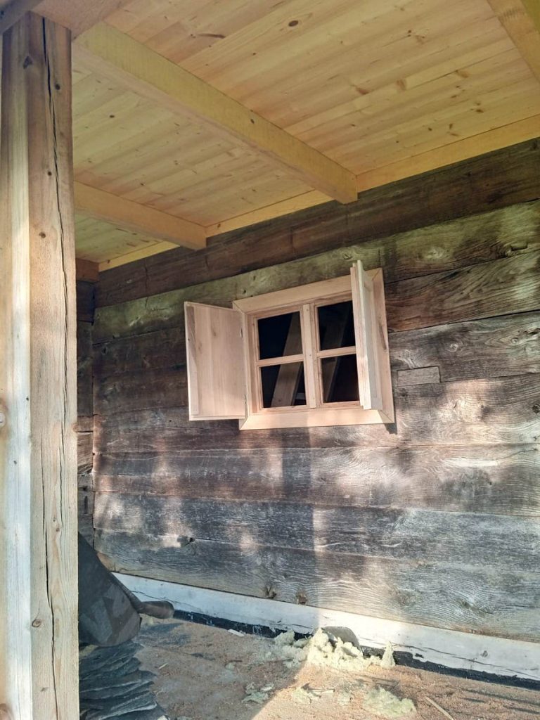 a new window on a wooden cottage