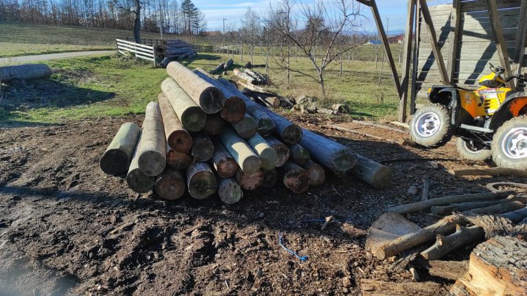 a pile of wooden poles
