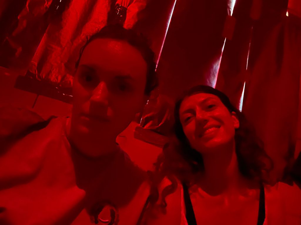 women posing in a darkroom under the red light
